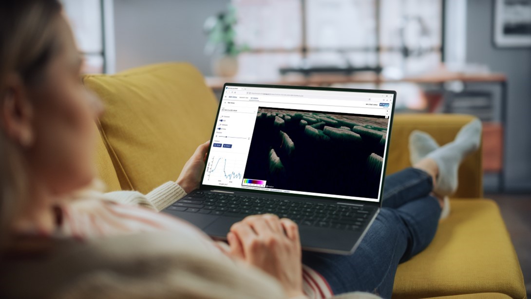 CouchSurveying SDB-Online - App by EOMAP - woman processing satellite-derived bathymetry on the sofa